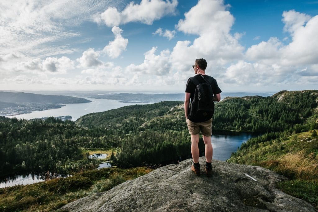 hiker overlooking a river and forrest